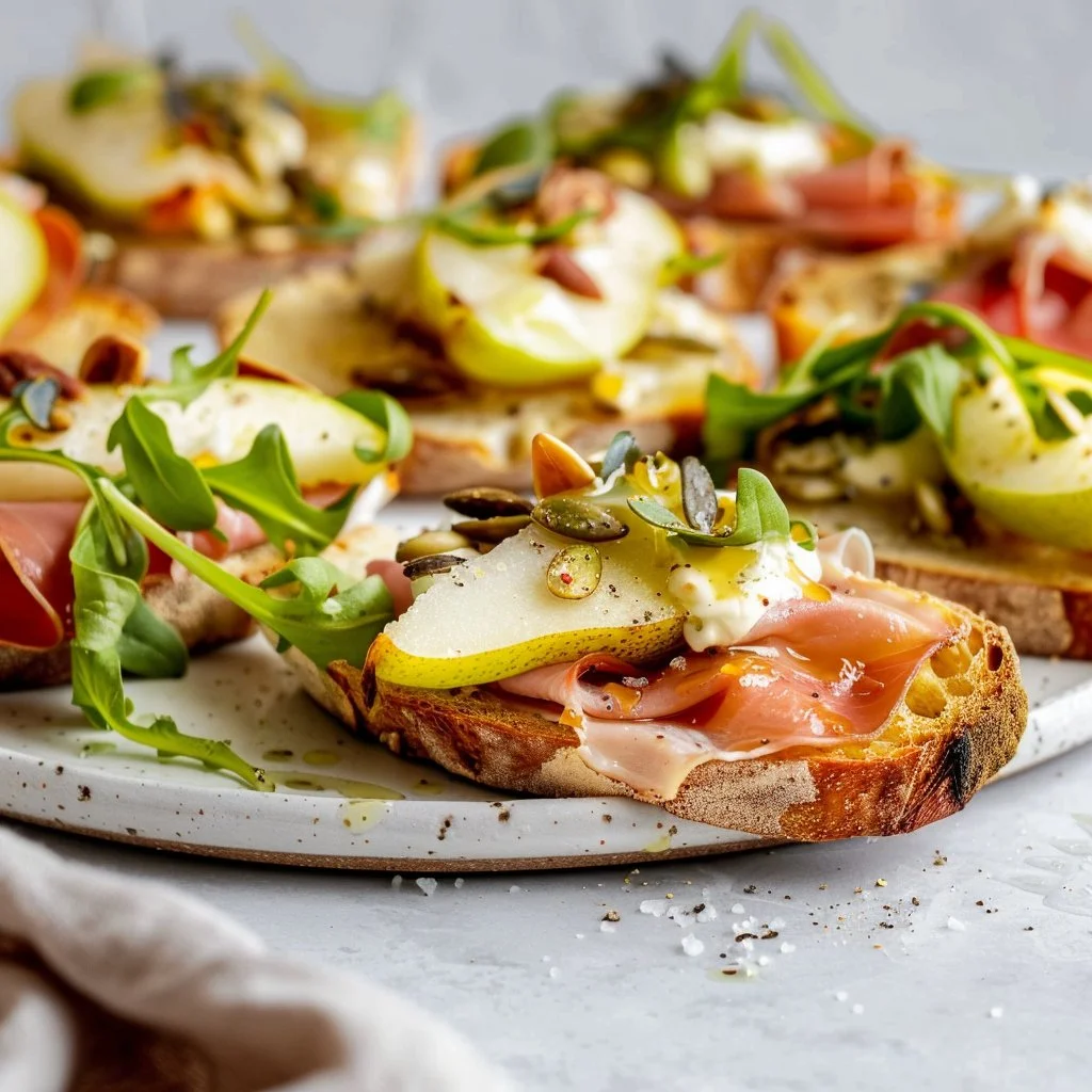 Delicious Pear Prosciutto Crostini appetizer topped with fresh ingredients
