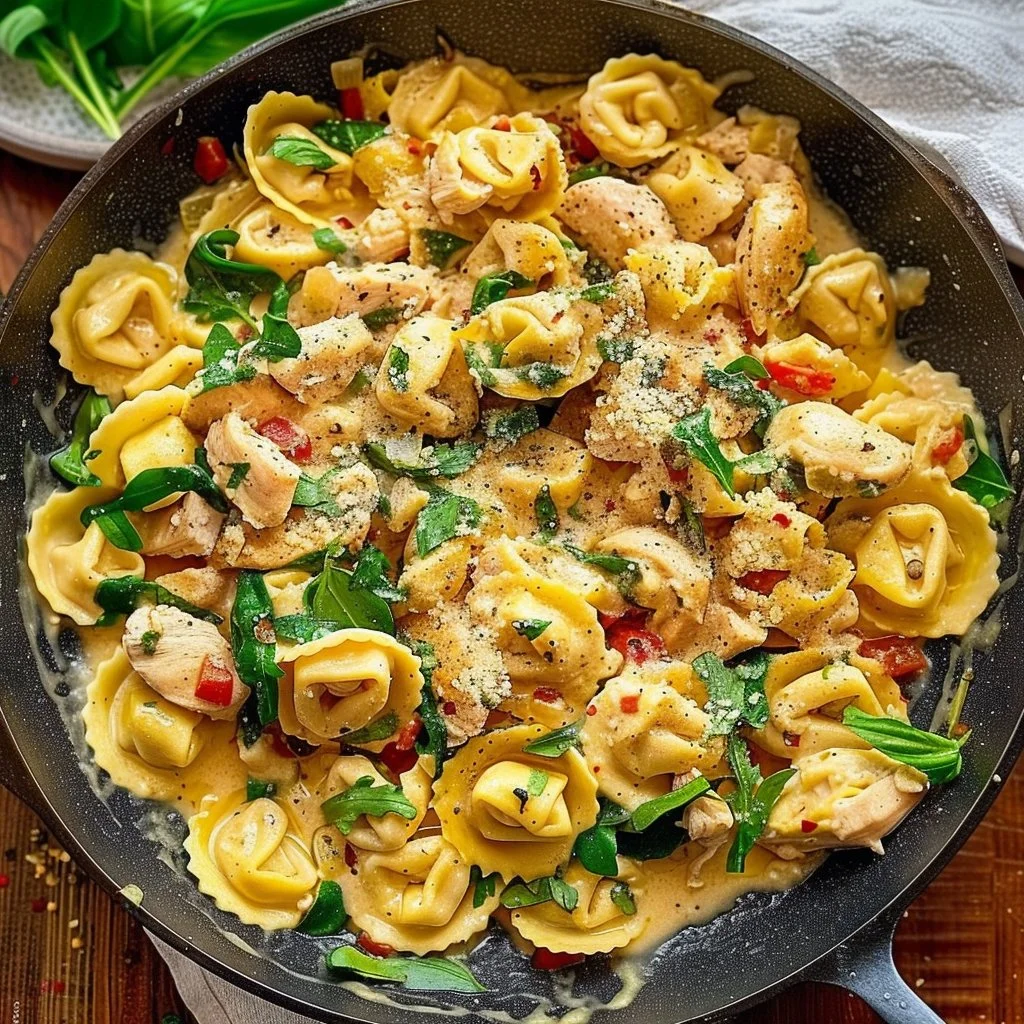 Creamy Tuscan Chicken Tortellini served in a bowl with fresh herbs.