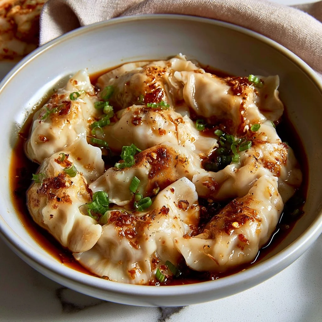 Pan-seared cabbage and shiitake dumplings served on a plate